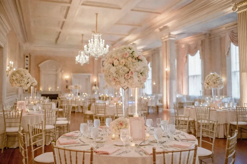 Elegant hotel banquet hall set up for a wedding with round tables and flower centrepieces
