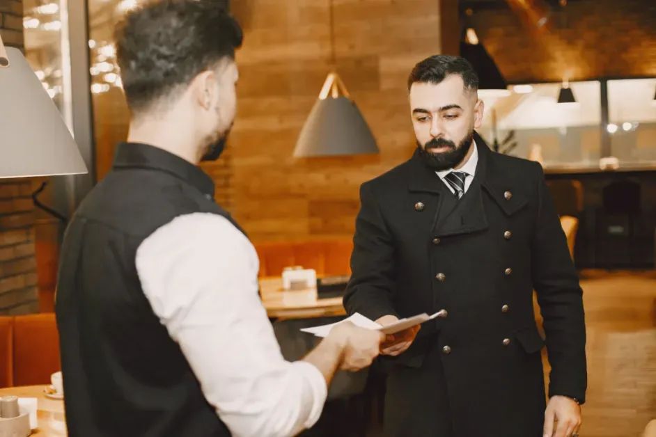 Hotel front desk staff using hotel management software