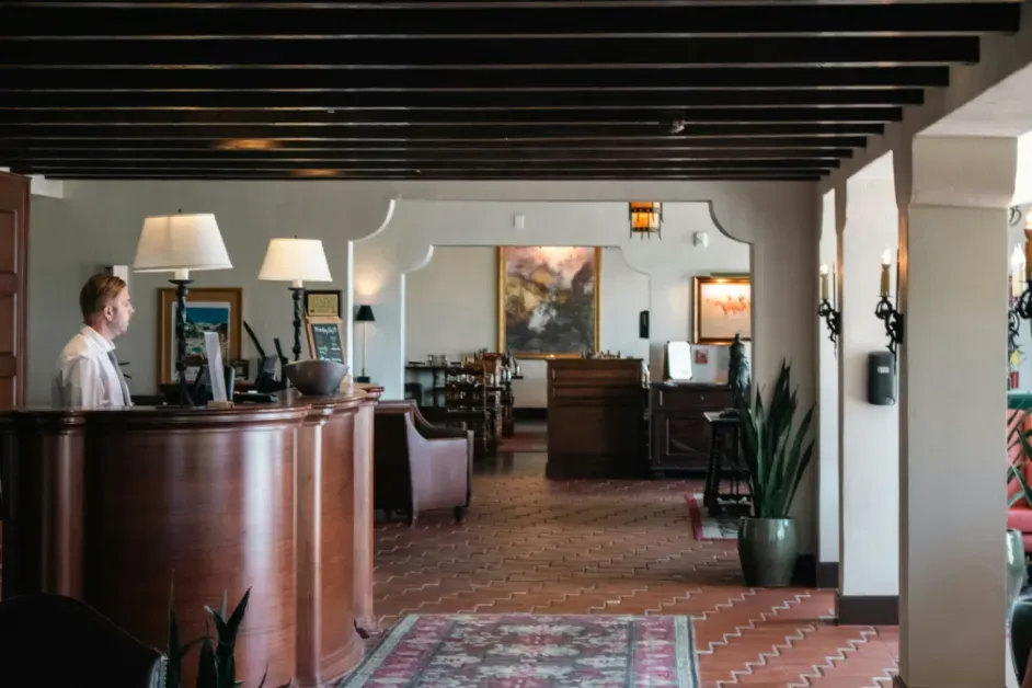 Hotel front-desk staff using advanced software to manage reservations, guest services, and hotel operations.