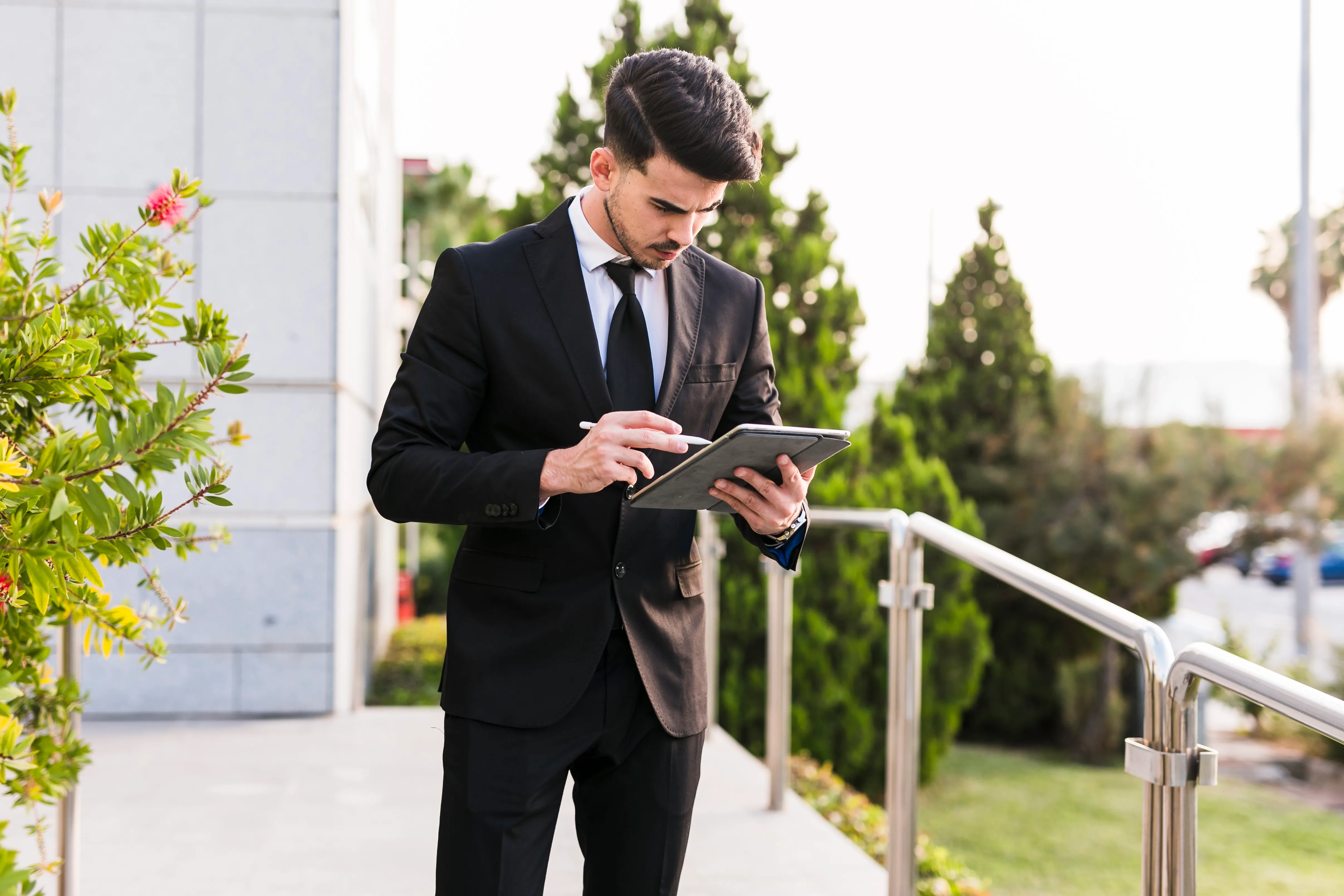 Hotel housekeeping staff using a digital tablet to manage room cleaning and housekeeping tasks