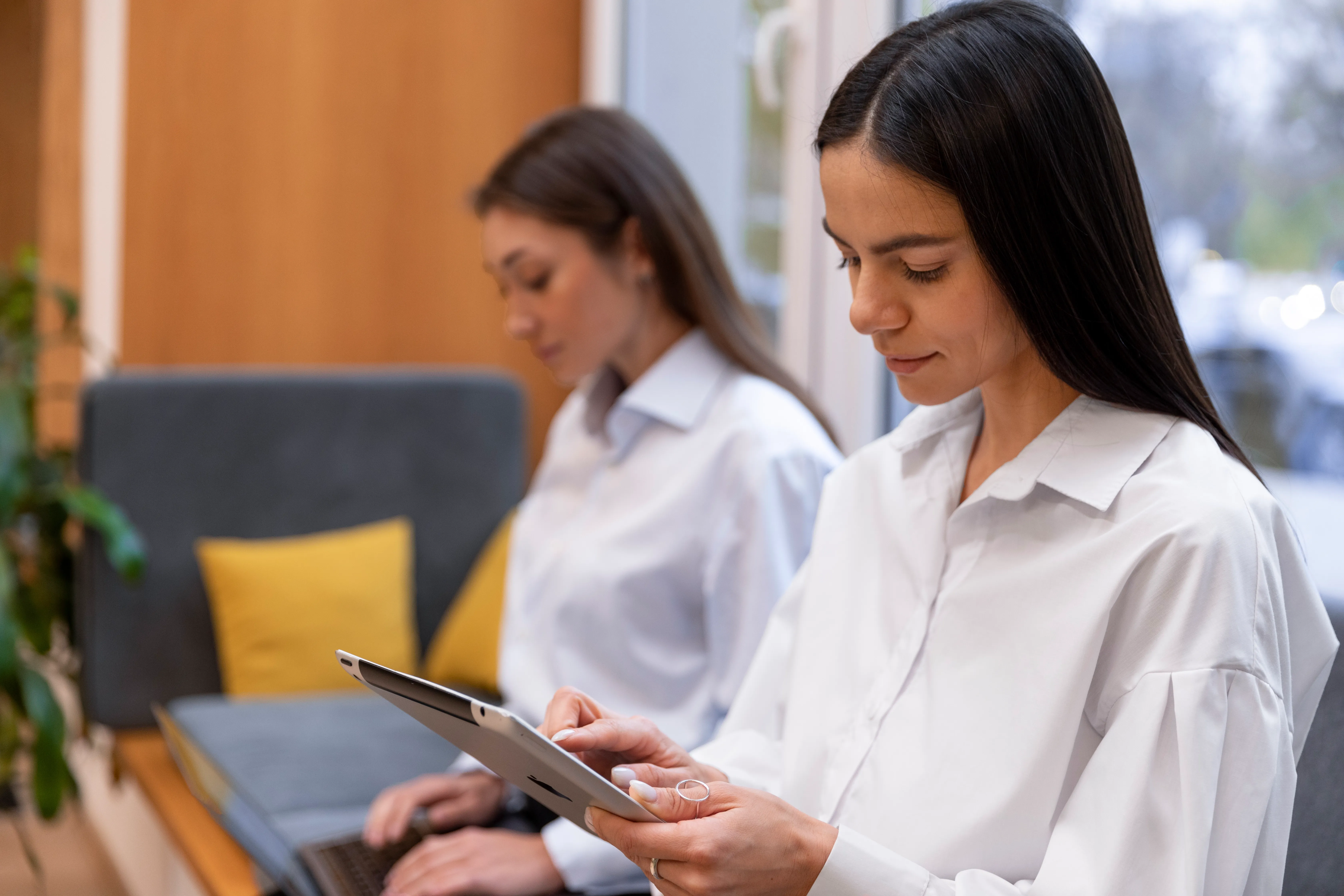 Hotel staff using a property management system on a tablet to manage hotel operations